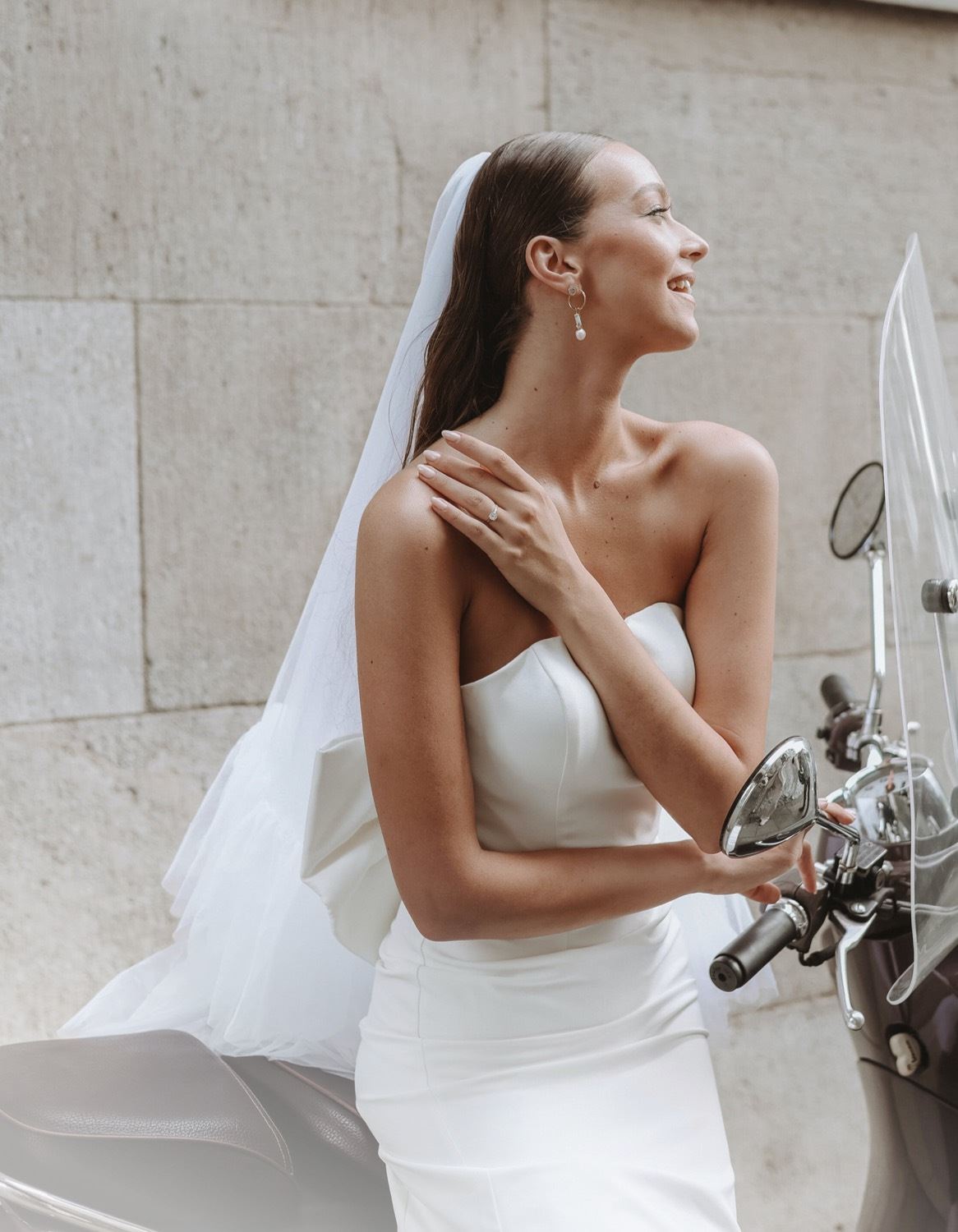 Photo of model wearing a white bridal gown on a scooter - desktop image